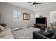 Living room with gray couch, patterned rug, and hardwood floors at 11518 Hammock Oaks Ct, Lithia, FL 33547