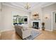 Living room with fireplace and view of the pool at 11518 Hammock Oaks Ct, Lithia, FL 33547