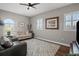 Living room with gray couch, patterned rug, and hardwood floors at 11518 Hammock Oaks Ct, Lithia, FL 33547
