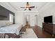 Main bedroom with hardwood floors, and access to the bathroom at 11518 Hammock Oaks Ct, Lithia, FL 33547
