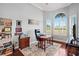 Home office with built-in shelving, desk, and large window at 11518 Hammock Oaks Ct, Lithia, FL 33547