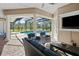 Relaxing patio area with covered seating, overlooking the pool and backyard at 11518 Hammock Oaks Ct, Lithia, FL 33547