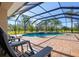 Refreshing screened pool with a spa, surrounded by a brick patio and lush greenery at 11518 Hammock Oaks Ct, Lithia, FL 33547