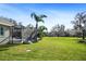 Screened pool and deck overlooking expansive backyard at 11518 Hammock Oaks Ct, Lithia, FL 33547