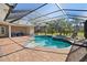 Sparkling screened pool and spa with brick patio, perfect for outdoor entertaining at 11518 Hammock Oaks Ct, Lithia, FL 33547