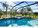 Inviting screened pool and spa with lounge chairs, overlooking a lush landscape at 11518 Hammock Oaks Ct, Lithia, FL 33547
