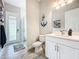 Modern bathroom with a walk-in shower and white cabinets at 13028 Homestead Ln, Parrish, FL 34219