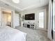 Main bedroom with TV, fireplace, and private access to backyard at 13028 Homestead Ln, Parrish, FL 34219