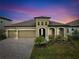 Two-story house with a three-car garage and landscaped yard at 13028 Homestead Ln, Parrish, FL 34219