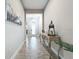 Elegant hallway with a decorative console table and art at 13028 Homestead Ln, Parrish, FL 34219