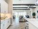Kitchen with white cabinetry, island seating, and view to living room at 13028 Homestead Ln, Parrish, FL 34219