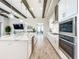 Modern kitchen with white cabinets, large island, and stainless steel appliances at 13028 Homestead Ln, Parrish, FL 34219