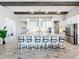 Modern kitchen with white cabinets, large island, and stainless steel appliances at 13028 Homestead Ln, Parrish, FL 34219