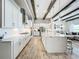 Modern kitchen with white cabinets, large island, and stainless steel appliances at 13028 Homestead Ln, Parrish, FL 34219