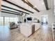 Modern kitchen with white cabinets, large island, and stainless steel appliances at 13028 Homestead Ln, Parrish, FL 34219