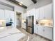 Modern kitchen with white cabinets, large island, and stainless steel appliances at 13028 Homestead Ln, Parrish, FL 34219