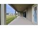 Extended covered patio overlooking the backyard and green space at 13028 Homestead Ln, Parrish, FL 34219
