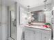 Clean bathroom with a vanity, granite countertop, and walk-in shower at 131 Bluff View Dr # 103, Belleair Bluffs, FL 33770