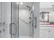 Updated bathroom with walk-in shower, grab bars, and granite vanity at 131 Bluff View Dr # 103, Belleair Bluffs, FL 33770