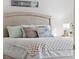 Main bedroom with a plush bed and soft color palette at 131 Bluff View Dr # 103, Belleair Bluffs, FL 33770