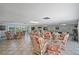 Relaxing common area with wicker furniture and games at 131 Bluff View Dr # 103, Belleair Bluffs, FL 33770