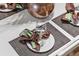 Elegant dining table setting with brown and green napkins at 131 Bluff View Dr # 103, Belleair Bluffs, FL 33770