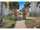 Attractive entrance gate with landscaping and walkway at 131 Bluff View Dr # 103, Belleair Bluffs, FL 33770