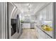 Modern white kitchen with stainless steel appliances and granite countertops at 131 Bluff View Dr # 103, Belleair Bluffs, FL 33770