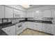 Efficient kitchen featuring white cabinets and appliances at 131 Bluff View Dr # 103, Belleair Bluffs, FL 33770