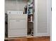 Laundry room with washer, dryer, and storage shelves at 131 Bluff View Dr # 103, Belleair Bluffs, FL 33770