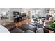 Living room with hardwood floors, leather furniture, and balcony access at 131 Bluff View Dr # 103, Belleair Bluffs, FL 33770