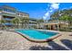 Inviting community pool with surrounding patio and building at 131 Bluff View Dr # 103, Belleair Bluffs, FL 33770
