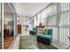 Bright sunroom with seating area and access to outdoors at 131 Bluff View Dr # 103, Belleair Bluffs, FL 33770