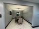 Modern dining room with gray walls, marble floors, and a wood table at 13828 Tonya Anne Dr, Riverview, FL 33579
