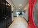 Bright entryway with red door, black double doors, and tile floors at 13828 Tonya Anne Dr, Riverview, FL 33579