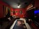 Home theater with red walls, large sectional sofa, and movie decor at 13828 Tonya Anne Dr, Riverview, FL 33579