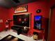 Home theater with red walls, large TV, and movie theme decor at 13828 Tonya Anne Dr, Riverview, FL 33579