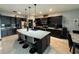 Spacious kitchen featuring dark cabinetry, granite countertops, and an oversized island at 13828 Tonya Anne Dr, Riverview, FL 33579