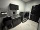 Laundry room with washer, dryer, and dark cabinets at 13828 Tonya Anne Dr, Riverview, FL 33579