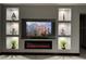 Living room with built-in shelving, fireplace, and black couches at 13828 Tonya Anne Dr, Riverview, FL 33579