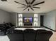 Living room with black leather couches and a built-in entertainment center at 13828 Tonya Anne Dr, Riverview, FL 33579