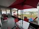 Relaxing screened patio overlooking a lake, complete with seating and a grill at 13828 Tonya Anne Dr, Riverview, FL 33579