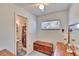 Bedroom with built-in dresser, small bathroom, and window at 1536 W Del Webb Blvd, Sun City Center, FL 33573