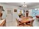 Charming dining room with wood table, chandelier and views to living room at 1536 W Del Webb Blvd, Sun City Center, FL 33573