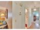 Hallway with light wood flooring and access to bathroom and bedroom at 1536 W Del Webb Blvd, Sun City Center, FL 33573
