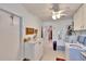 Bright laundry room with washer, dryer, and extra counter space at 1536 W Del Webb Blvd, Sun City Center, FL 33573