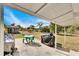 Covered patio with outdoor seating, grill, and ample space at 1536 W Del Webb Blvd, Sun City Center, FL 33573