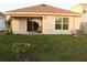 Backyard patio with sliding glass doors leading inside and a chaise lounge at 1668 Hazy Sea Dr, Plant City, FL 33565