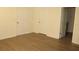 Bright bedroom showcases two white doors and stylish wood-look flooring at 1668 Hazy Sea Dr, Plant City, FL 33565
