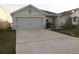 Charming single-story home with a two-car garage and well-maintained landscaping at 1668 Hazy Sea Dr, Plant City, FL 33565